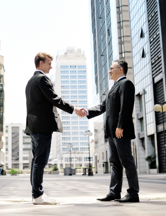 Two business professionals shake hands.